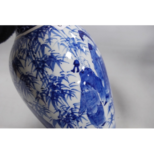 278 - Pair of Delft-style blue and white vases in the Japanese taste, decorated with figures in foliage, u... 