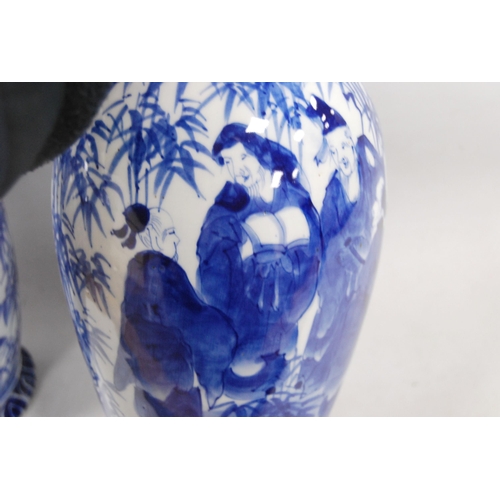 278 - Pair of Delft-style blue and white vases in the Japanese taste, decorated with figures in foliage, u... 