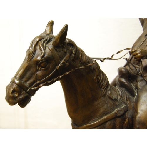 198 - In the Manner of Frederick RemingtonCast bronze figure group modelled as a cowboy on horseback, on f... 