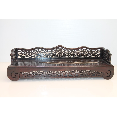 16 - Oriental fret cut treen stand, 37.5cm.