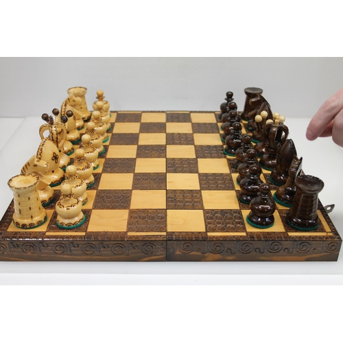 7 - Treen travel chess set, 40cm.