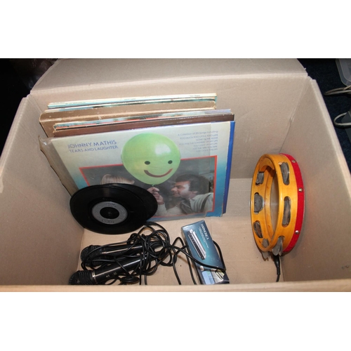 216 - Box containing records, two microphones, a harmonica, etc.