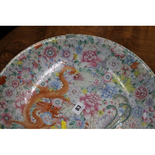 83 - Large oriental shallow bowl decorated with a dragon amongst flowers, character mark to base, 40cm di... 