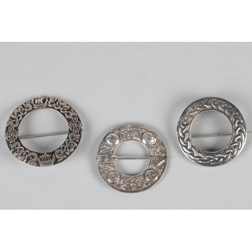 103 - Three hallmarked silver 'Celtic' design brooches; 47g gross weight