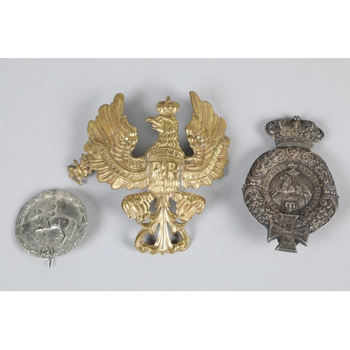 128 - World War II German tinplate helmet badge; and two German Imperial Badges