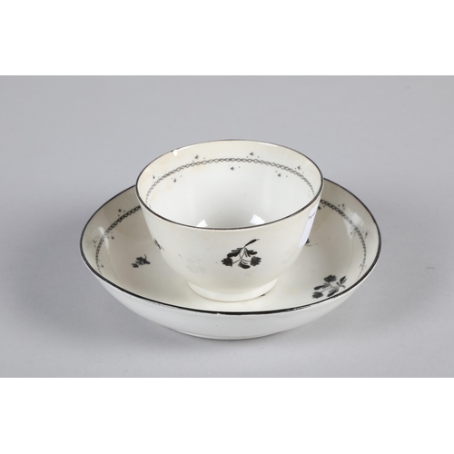 18 - 19th century English porcelain tea bowl and saucer; decorated with black leaves on cream ground