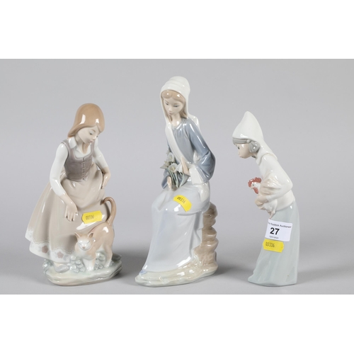 27 - Three Lladro porcelain figures; Child with Cockerel; Lady holding flowers and a lady with a cat; mar... 