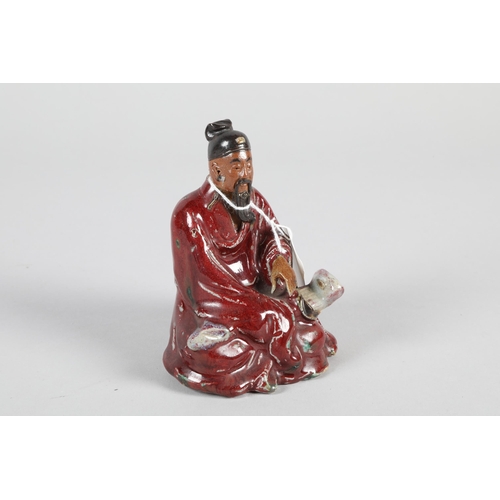 38 - Chinese porcelain porcelain seated scholar figure; possibly Qing Dynasty; 11cm high