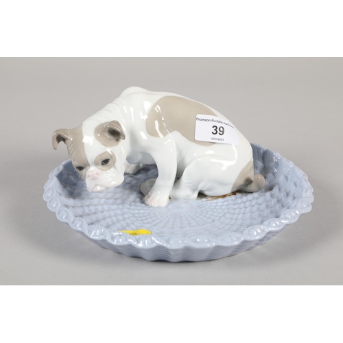 39 - Early 20th century porcelain model of a Bulldog sitting in a basket; impressed marks to base; 20cm d... 