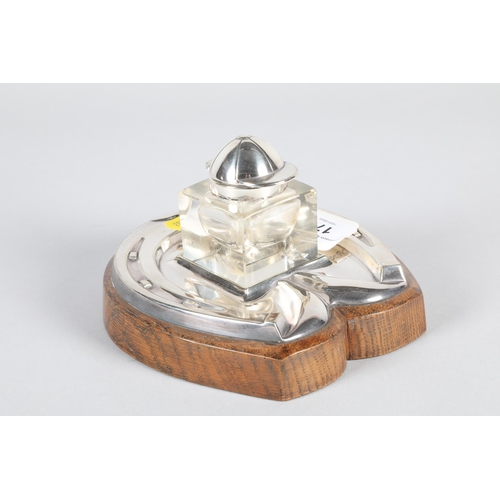 178 - Electro plated silver ink stand,in the form of a horseshoe, mounted to an oak base, glass inkwell wi... 