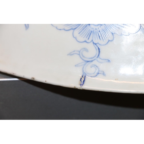 83 - Large oriental shallow bowl decorated with a dragon amongst flowers, character mark to base, 40cm di... 