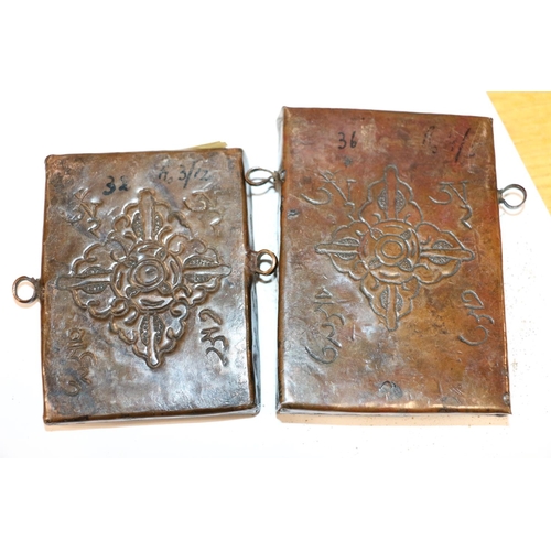 37 - Two embossed Indian copper panels, 10.5cm & 9cm.