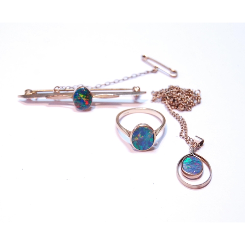 73 - Opal doublet bar brooch, a similar ring, '18ct', and a pendant.