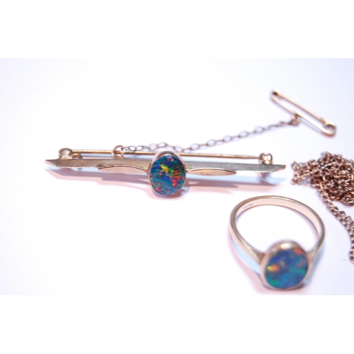 73 - Opal doublet bar brooch, a similar ring, '18ct', and a pendant.