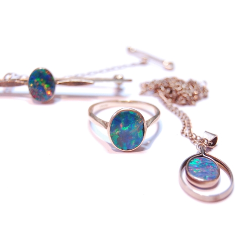 73 - Opal doublet bar brooch, a similar ring, '18ct', and a pendant.