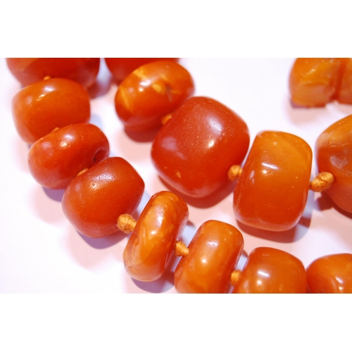 76 - Amber bead necklace of variegated circular beads, 146g.