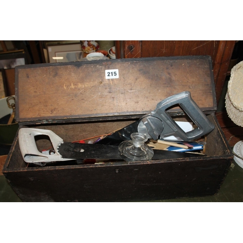 215 - Toolbox with two saws, pens, a glass inkwell.