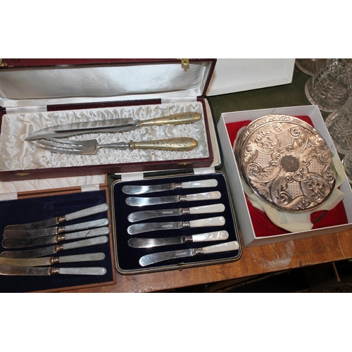 216 - Two boxed sets of butter knives, one with mother-of-pearl handles, also a carving set and coasters.