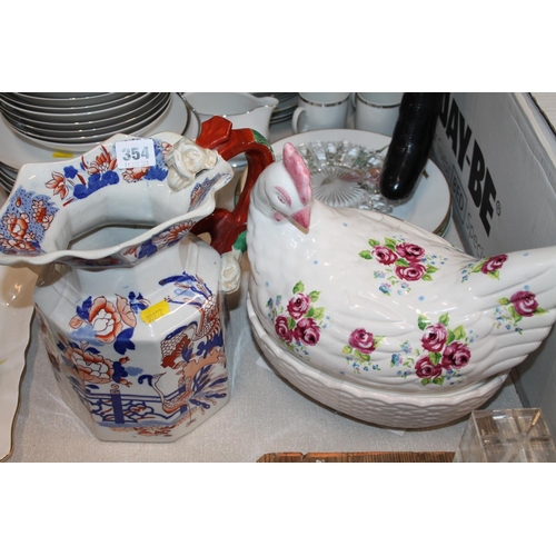 354 - 19th century Imari palette water pitcher, with a dragon handle, and a hen on nest egg holder.