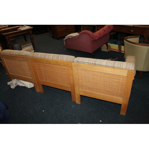 556 - Mid-century oak framed three seater sofa, with caned back, possibly Habitat.