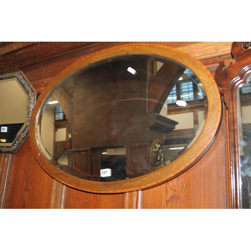 597 - Oval mahogany bevel glass wall mirror 50cm x 75cm.