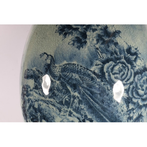 125A - Large oriental ceramic egg on stand decorated with birds of paradise.