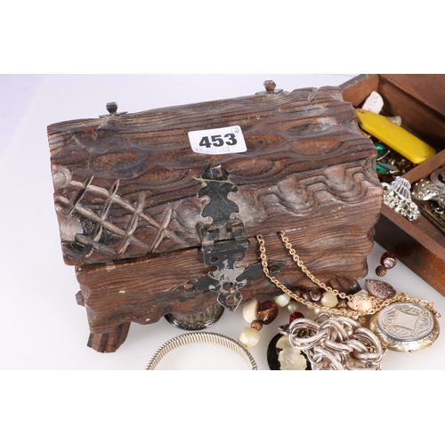 453 - Two wooden jewellery caskets containing costume jewellery to include filigree butterfly brooch, faux... 