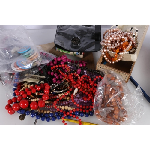 497 - Costume jewellery to include beaded necklaces, badges, etc.