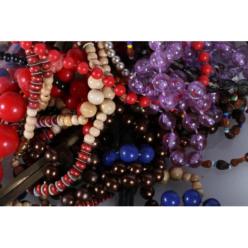 497 - Costume jewellery to include beaded necklaces, badges, etc.