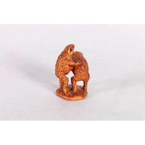 51 - Netsuke in the form of two standing toads, 5cm.