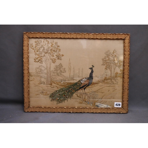 428 - 19th century needlework depicting a peacock in a landscape, 31cm x 42cm, frame 36cm x 47cm.