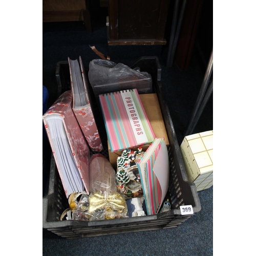 369 - Box containing Christmas decorations, photograph albums with a collection of Tottering-by-Gently by ... 