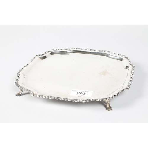 203 - George V hallmarked silver card tray with gadrooned border; raised on four outswept supports; 490g g... 