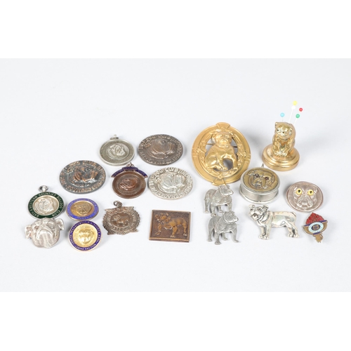 208 - White metal and brass 'bulldog' tape measure; together with assorted bulldog badges and a small bras... 