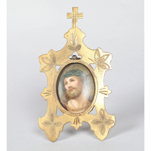 212 - 19th century painted porcelain panel of Jesus with crown of thorns; in a engraved brass easel frame;... 