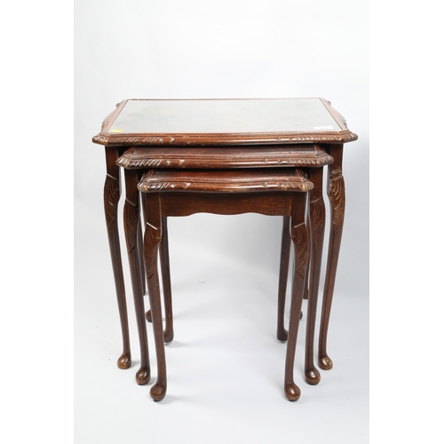 488 - Nest of three mahogany glass topped occasional tables; 53cm wide 