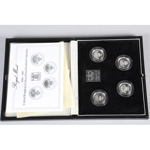 127 - Cased 1984 - 1987 Royal Mint United Kingdom £1 Silver Proof Piedfort Collection four piece coin set;... 