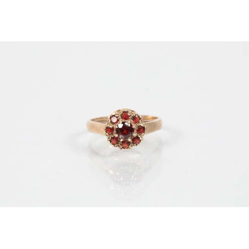 112 - 9 carat yellow gold and ruby set flower head cluster ring; ring size H; 2.1g gross weight