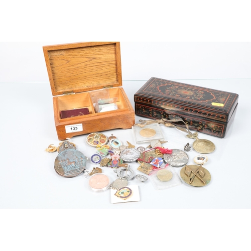 133 - Assorted coins and badges; in a lacquer and oak box