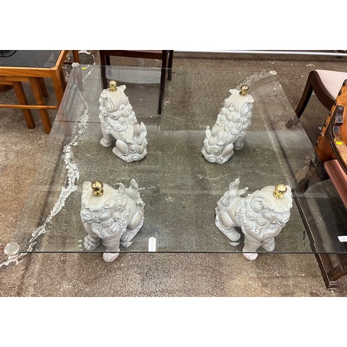 601 - Large glass top coffee table on four Oriental lions