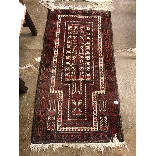 641 - Red / beige ground woollen rug, 140 x 75 cm