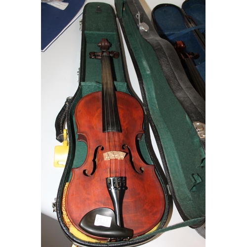 241 - Violin in fitted case, case inscribed made in the Peoples Republic of China and another with bow, bo... 