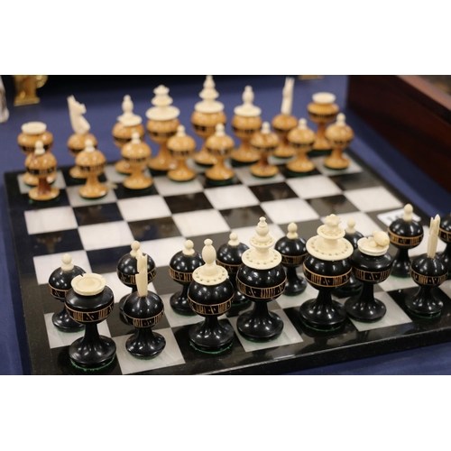 145 - Turned treen chess set on a hardstone chessboard.