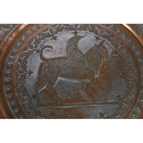 14 - Two Indian copper chargers, one decorated with mythical beast, the other decorated with a farming sc... 