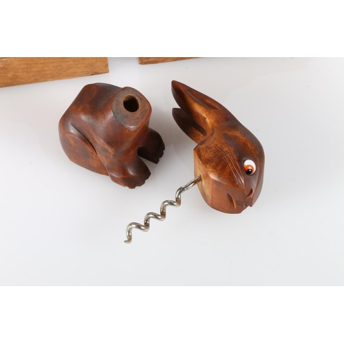 24 - Pair of carved treen dog bookends, and a similar treen rabbit.