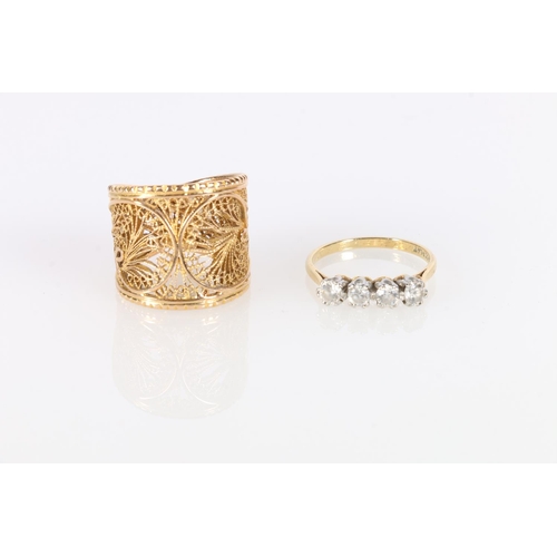 592 - Yellow metal ring with pierced foliate design, size Q and 4 stone gold plated ring size Q. 