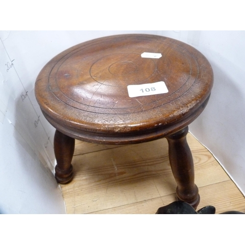 108 - Three-legged milking stool and a pair of ebony elephant bookends.
