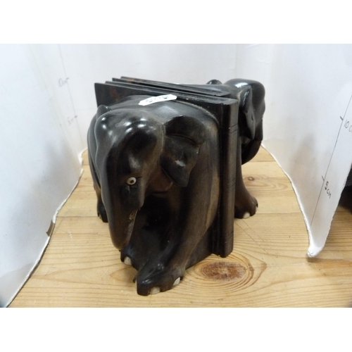 108 - Three-legged milking stool and a pair of ebony elephant bookends.