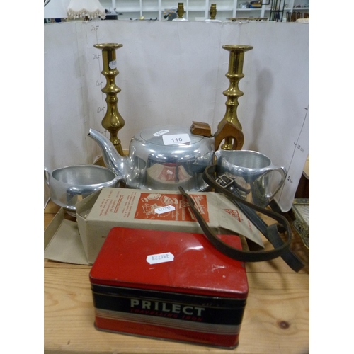 110 - Three-piece Picquot ware tea set, pair of brass candlesticks, travel iron etc.