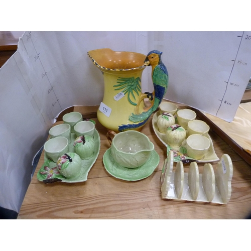 111 - Burslem parrot decorated jug, two Maling-type condiment sets, another similar toast rack and a sauce... 